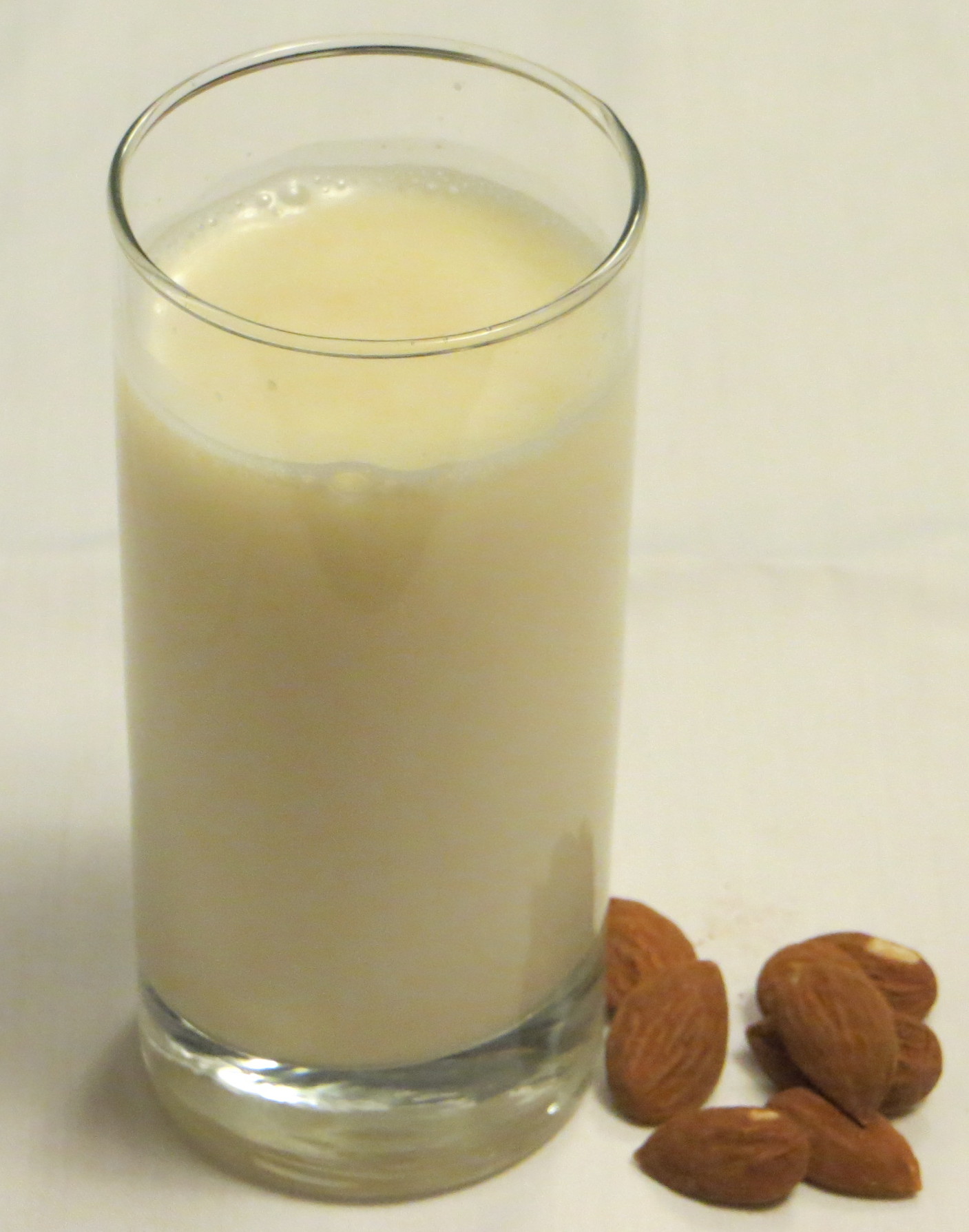 Glass of Almond milk and almonds
